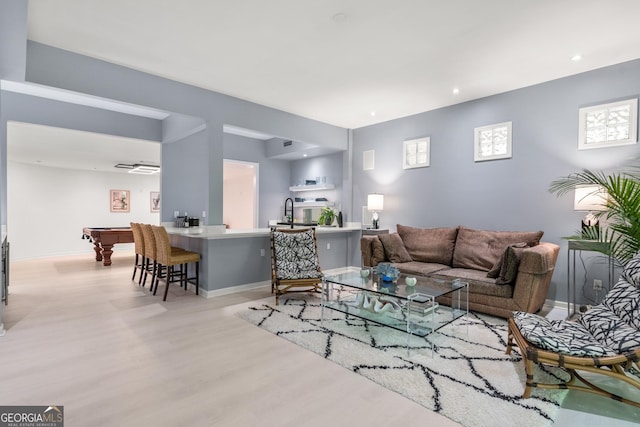 living room featuring light hardwood / wood-style floors and pool table