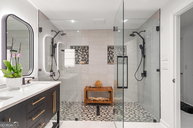 bathroom with vanity and a shower with door