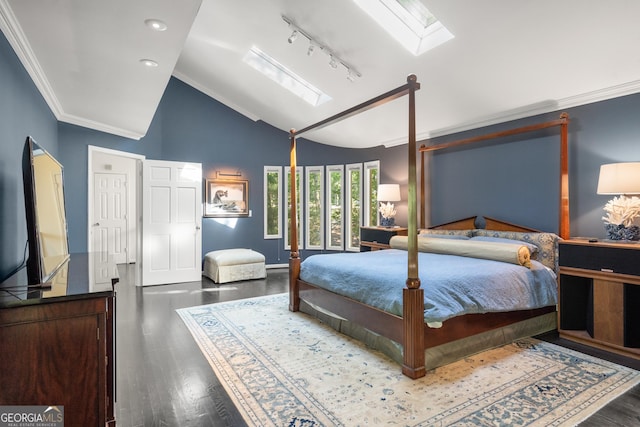 bedroom featuring ornamental molding, rail lighting, lofted ceiling with skylight, and dark wood-type flooring