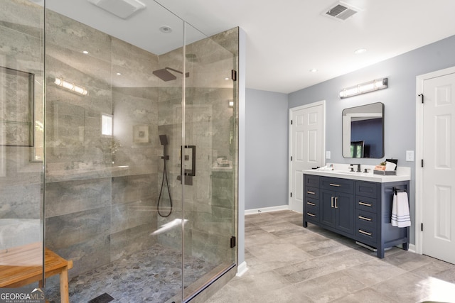 bathroom with vanity and a shower with shower door