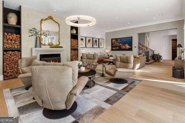 living room featuring light hardwood / wood-style floors and ornamental molding