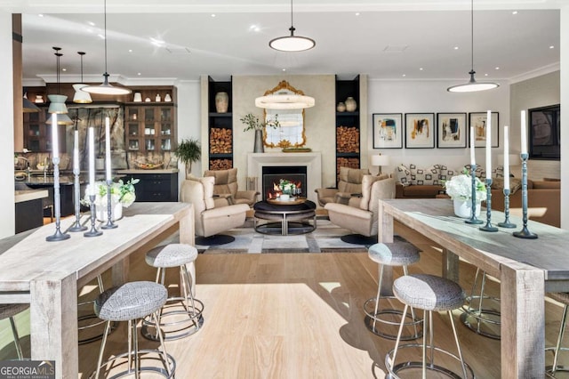 living room with light hardwood / wood-style flooring and ornamental molding