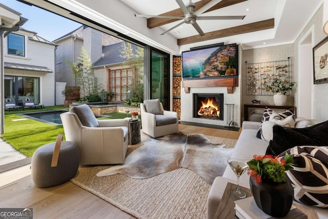 interior space with hardwood / wood-style floors, ceiling fan, and a large fireplace