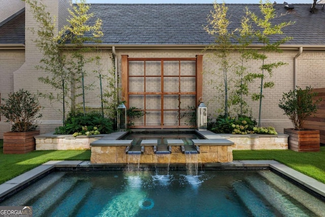 view of swimming pool featuring an in ground hot tub and pool water feature