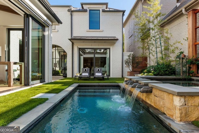 rear view of property with pool water feature