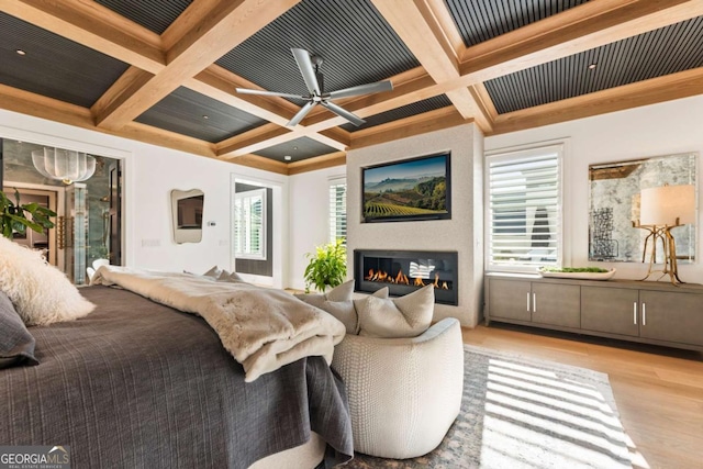 bedroom featuring beam ceiling, multiple windows, and coffered ceiling