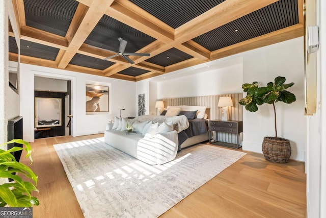 bedroom featuring beamed ceiling, coffered ceiling, and light wood-type flooring