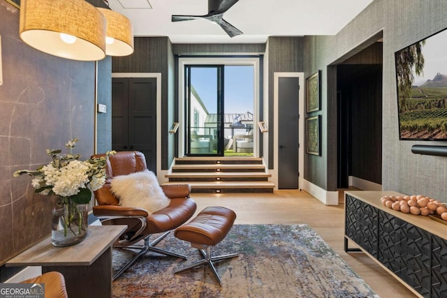 sitting room featuring ceiling fan and light wood-type flooring