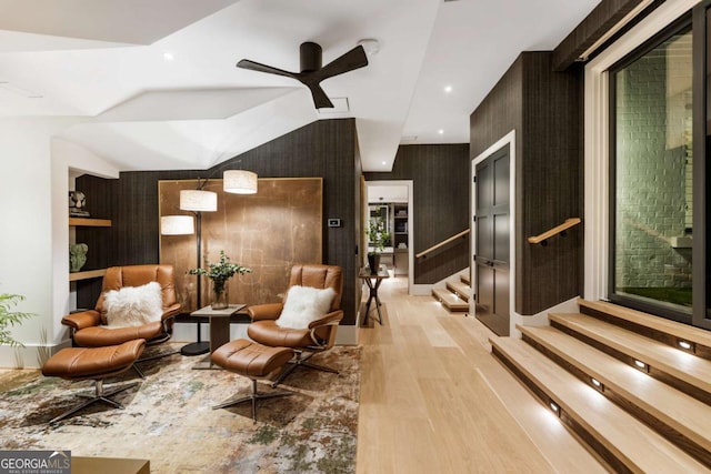 living area with light hardwood / wood-style flooring and ceiling fan