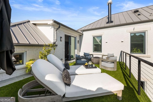 rear view of property with an outdoor living space