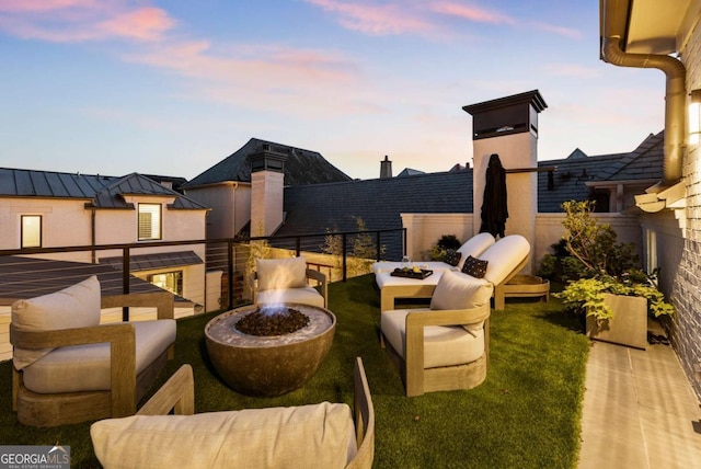 211 N Esplanade, Alpharetta, GA 30009 - patio terrace at dusk with an outdoor living space with a fire pit and a balcony