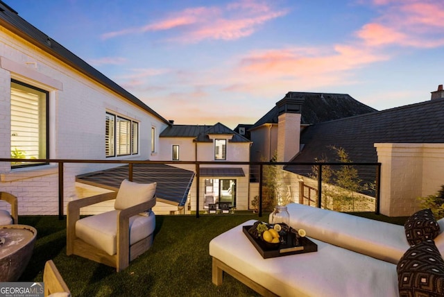 balcony at dusk with an outdoor living space