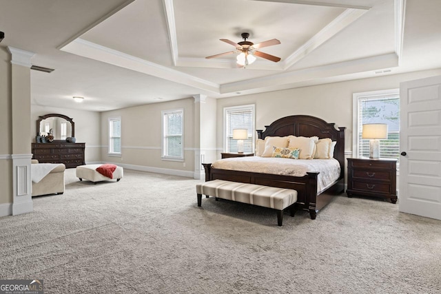 carpeted bedroom featuring ceiling fan, a raised ceiling, ornate columns, and crown molding