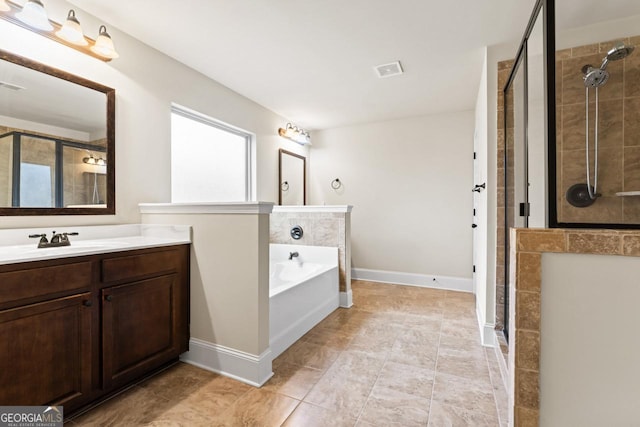 bathroom featuring vanity and shower with separate bathtub