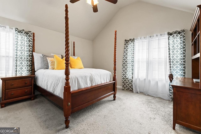 bedroom featuring multiple windows, light colored carpet, vaulted ceiling, and ceiling fan