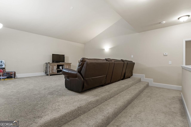 carpeted cinema room featuring vaulted ceiling