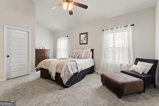 bedroom with ceiling fan, light carpet, and vaulted ceiling