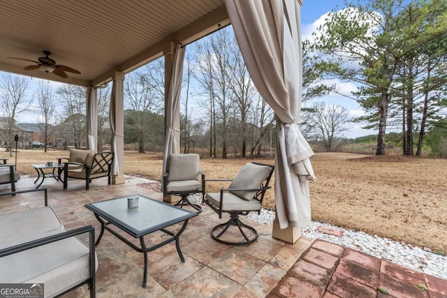 view of patio featuring ceiling fan