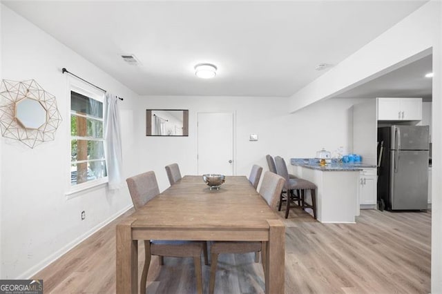 dining area with light hardwood / wood-style floors