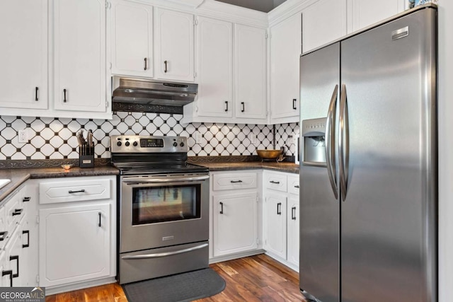 kitchen with backsplash, light hardwood / wood-style flooring, white cabinets, and appliances with stainless steel finishes