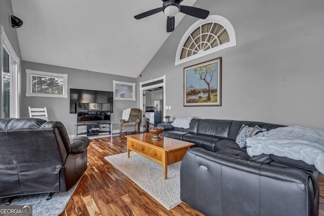 living room with dark hardwood / wood-style flooring, high vaulted ceiling, and ceiling fan