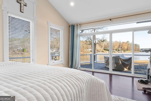 bedroom featuring access to exterior, a water view, multiple windows, and lofted ceiling