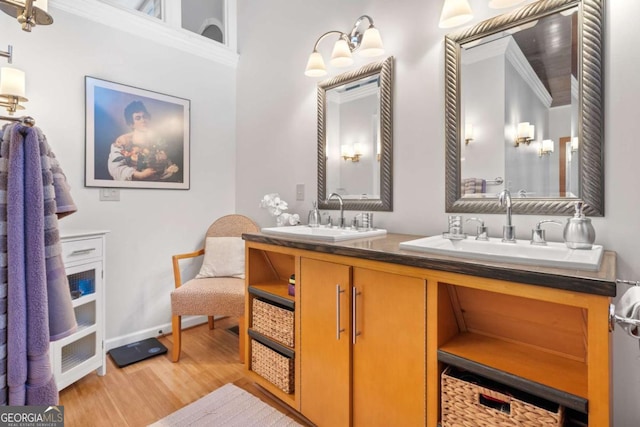 bathroom with hardwood / wood-style floors, vanity, and ornamental molding