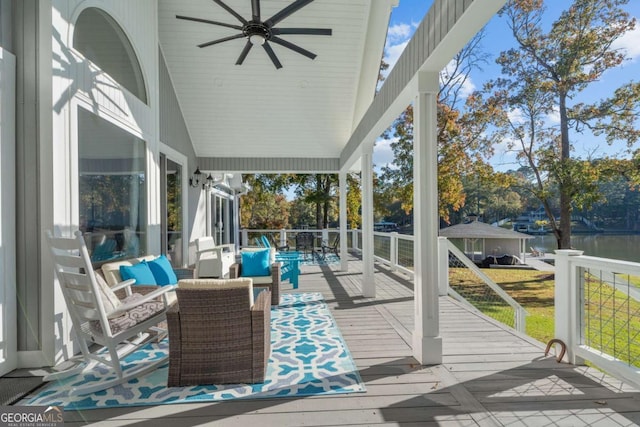 sunroom / solarium featuring ceiling fan, a water view, and lofted ceiling