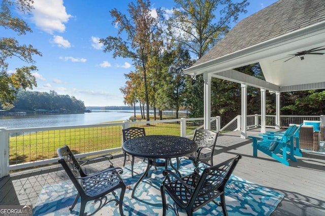 view of patio featuring ceiling fan and a deck with water view