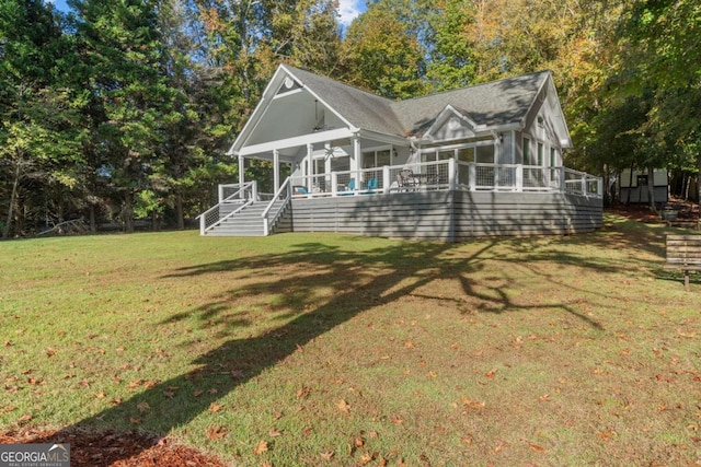 back of house featuring a yard and ceiling fan