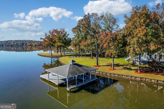 dock area featuring a water view and a lawn