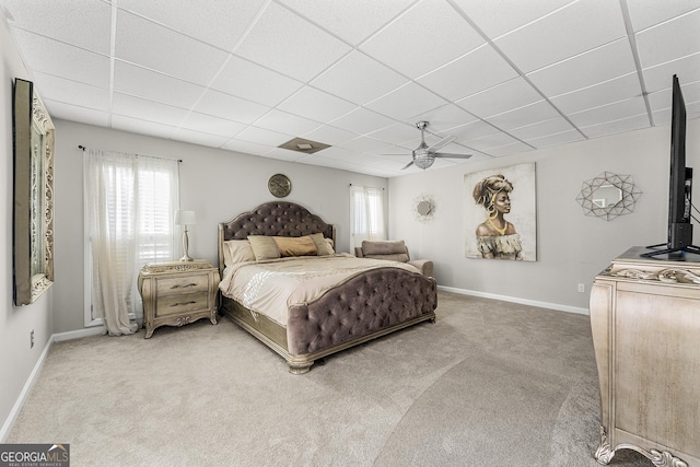 bedroom with ceiling fan, multiple windows, a paneled ceiling, and carpet flooring