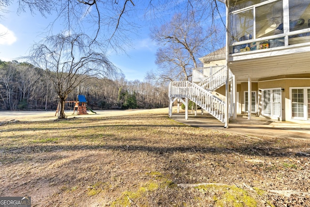 view of yard with a playground and a patio