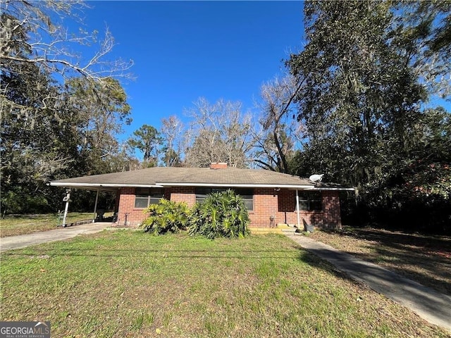 view of front facade with a carport and a front lawn