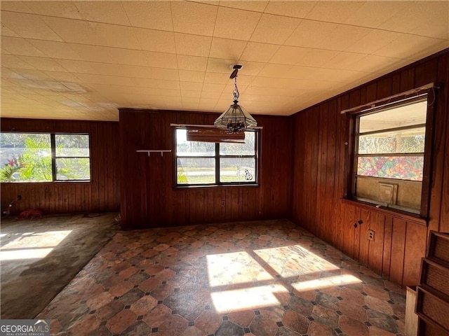 unfurnished dining area with wooden walls