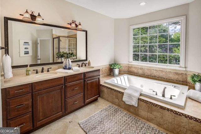 bathroom featuring tile patterned flooring, plenty of natural light, plus walk in shower, and vanity