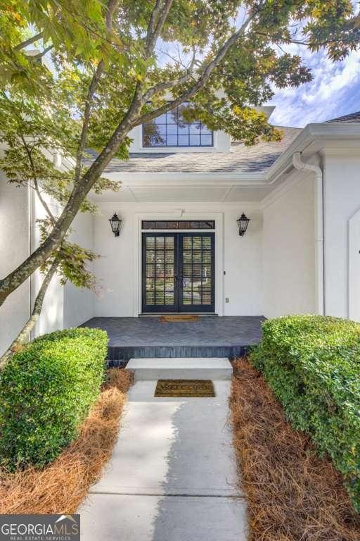 doorway to property featuring french doors and a porch