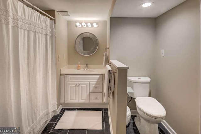 bathroom with tile patterned flooring, vanity, and toilet