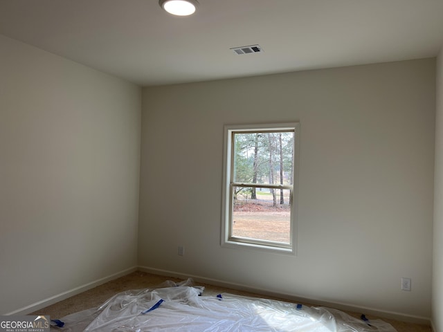 unfurnished room with visible vents and baseboards