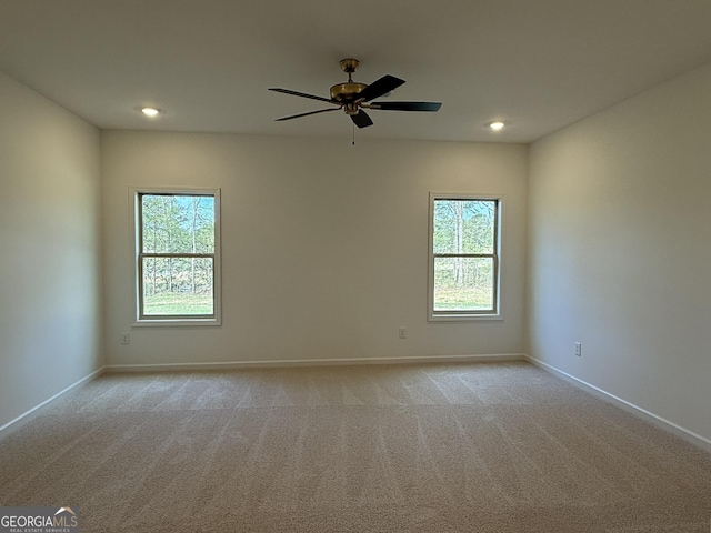 unfurnished room featuring light colored carpet, recessed lighting, baseboards, and a ceiling fan