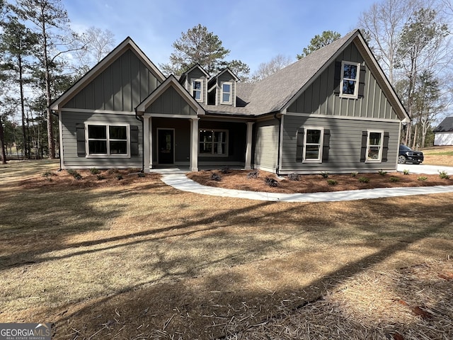 view of front of property with board and batten siding, a porch, and roof with shingles