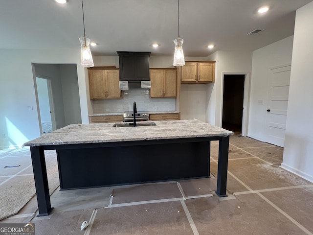 kitchen with light stone counters, a sink, under cabinet range hood, backsplash, and recessed lighting