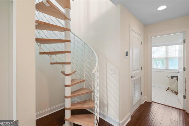 stairs featuring wood-type flooring