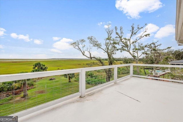 view of patio featuring a rural view and a balcony