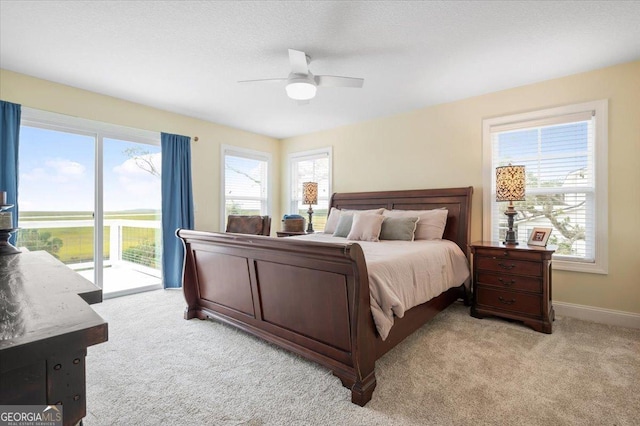 carpeted bedroom featuring access to outside and ceiling fan