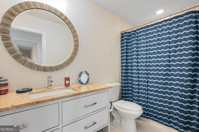 bathroom featuring tile patterned flooring, vanity, a textured ceiling, and toilet