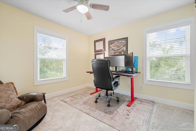 carpeted office with plenty of natural light and ceiling fan