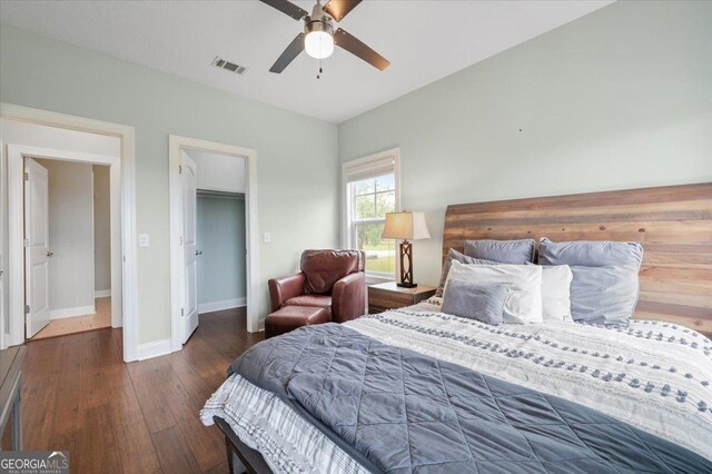 bedroom featuring ceiling fan, dark hardwood / wood-style flooring, and a closet