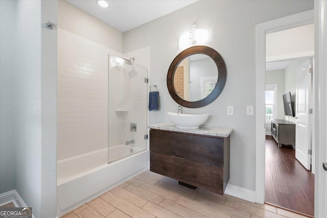 bathroom featuring vanity and tiled shower / bath