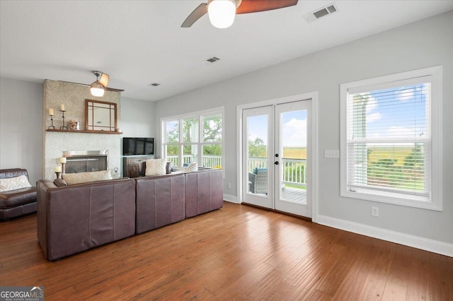 living room with ceiling fan, french doors, and hardwood / wood-style flooring